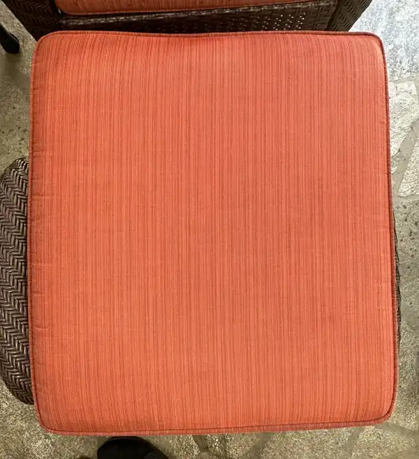 Coral woven seat cushion on a wicker chair, color even after cleaning